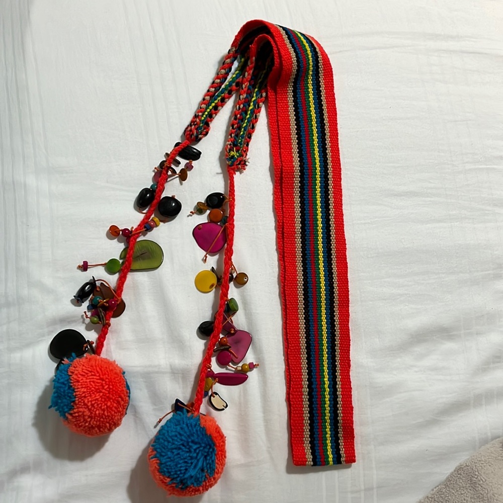 Wayuu colorful belt for women with pompons and natural accessories.